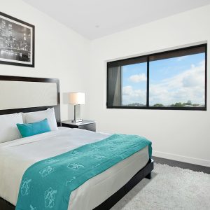 white bedspread and black wooden bed