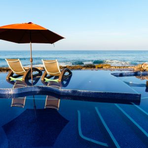 brown umbrella on swimming pool during daytime